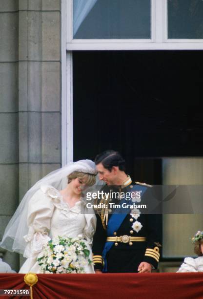 Prince Charles, Prince of Wales whispering to Diana, Princess of Wales on their wedding day as they appear on the balcony of Buckingham Palace