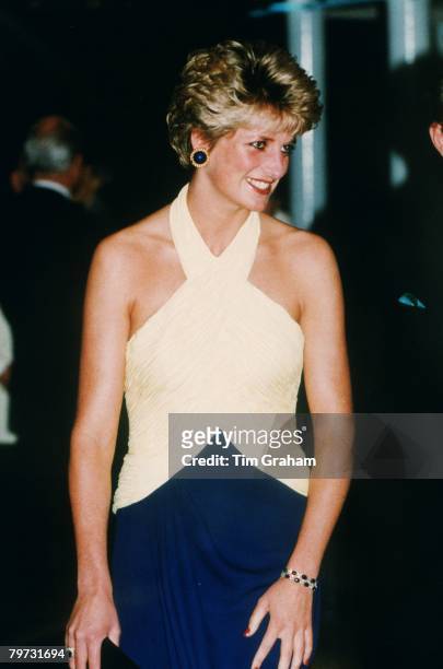 Diana, Princess of Wales attends the premiere of 'Far and Away' at the Leicester Square Empire Cinema, She is wearing a yellow and navy blue halter...