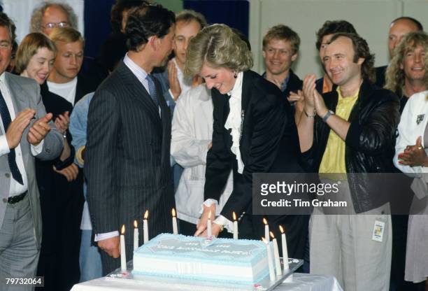 Diana, Princess of Wales and Prince Charles, Prince of Wales cutting a cake to celebrate ten years of the Prince's Trust Concert at Wembley, The...