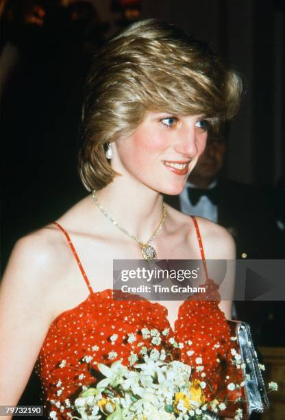 Diana, Princess of Wales wears a gold and diamond necklace in the shape of the Prince of Wales feathers for a visit to the Royal Opera House, Covent...