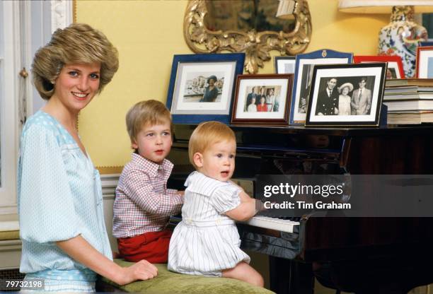 Diana, Princess of Wales with her sons, Prince William and Prince Harry, at the piano in Kensington Palace