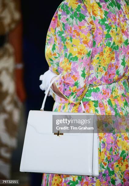 Queen Elizabeth II carries a white handbag with her during an official visit to RAF Akrotiri in Cyprus