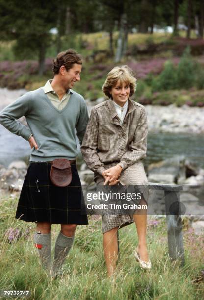 Prince Charles, Prince of Wales and Diana, Princess of Wales smile as they pose together during a honeymoon photocall by the River Dee, The Princess...