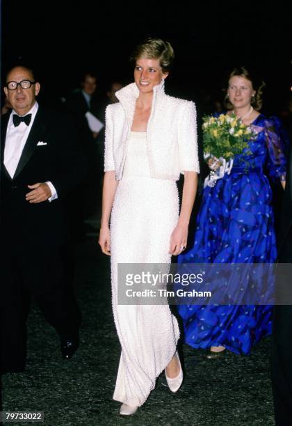 Diana, Princess of Wales wears a white Catherine Walker gown, known as the Elvis dress, with matching bolero jacket to the British Fashion Awards at...