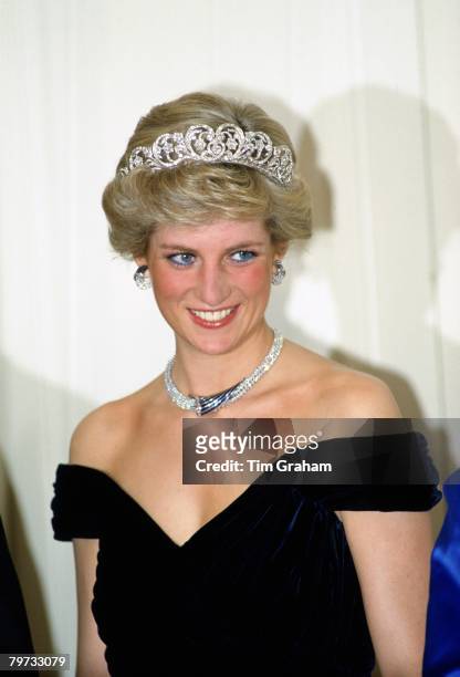 Diana, Princess of Wales wears a sapphire and diamond necklace, which was a gift from the Sultan of Oman, and the Spencer Tiara with a dress designed...