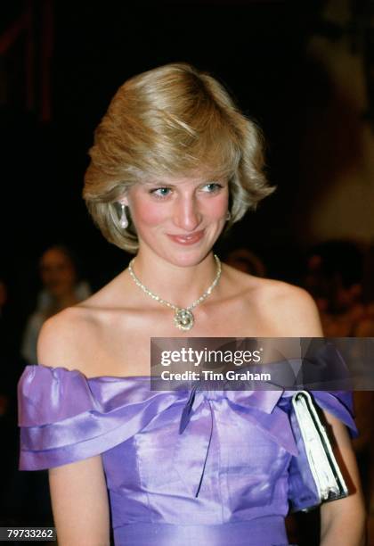 Diana, Princess of Wales attends the ballet "Coppelia" during her official tour of New Zealand, The Princess is wearing a mauve evening dress...