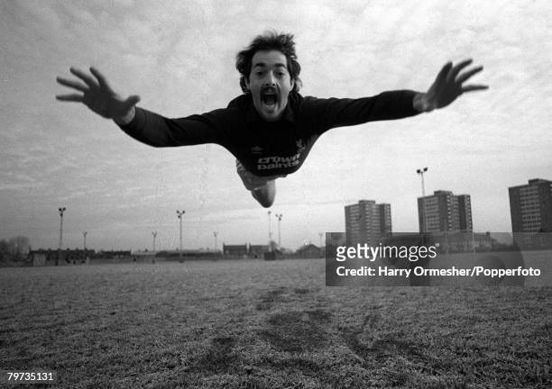 Liverpool FC keeper Bruce Grobbelaar appears to be mimicking Superman.while clowning around during a training session at Melwood, Liverpool, 1983.