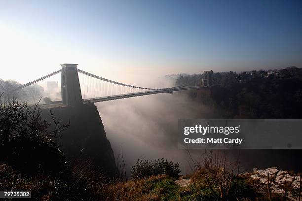 The sun's rays begin to clear the early morning mist around Clifton Suspension Bridge on February 13 in Bristol, United Kingdom. Spanning the Avon...