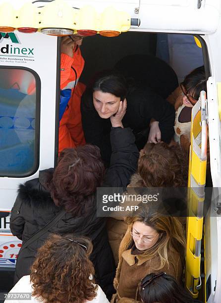 Teacher is comforted after a five-hour ordeal on February 13, 2008 in a nursery school in Reggio di Calabria, southern Italy. A man armed with a box...