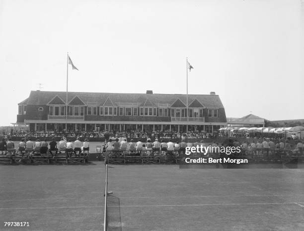 View of spectators as they watch a tennis match between 'Fox' and 'Mark' at the Meadow Club, Southampton, New York, 1940s.