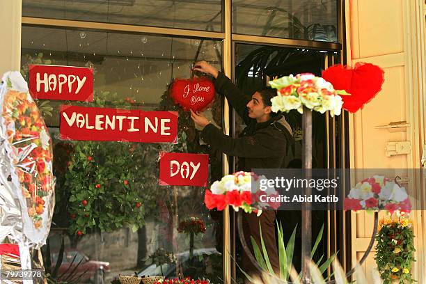 Palestinian flower vendor decorates his shop as he prepares to celebrate on the eve of Valentine's Day on February 13, 2008 in Gaza city, Gaza Strip....