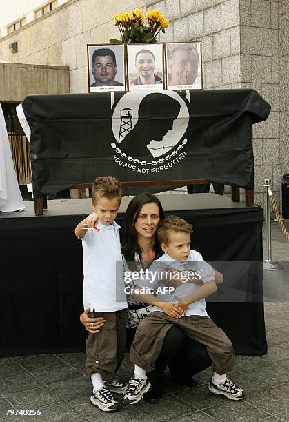 Keith Stansel's wife Patricia Medina huges her sons Keith and Nicolas during a remembrance ceremony at US Embassy on February 13 2008, in Bogota. US...