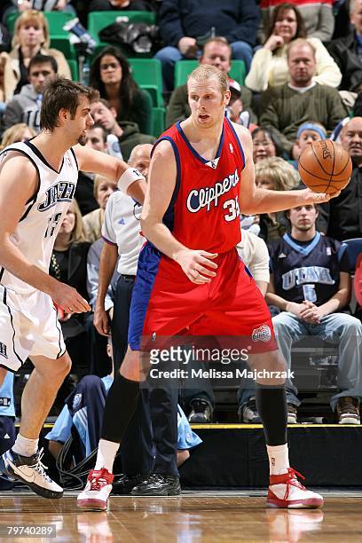 Chris Kaman of the Los Angeles Clippers goes up against Mehmet Okur of the Utah Jazz during the game on January 18, 2008 at EnergySolutions Arena in...