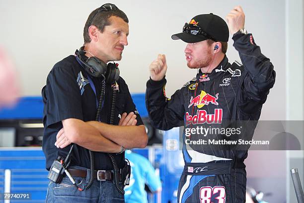 Guenther Steiner , the technical director for Red Bull Racing Team, talks with Brian Vickers, driver of the Red Bull Toyota, in the garage during...