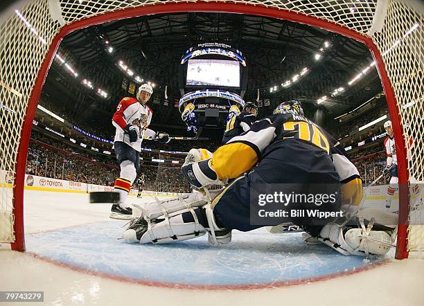 Stephen Weiss of the Florida Panthers watches the shot of teammate Branislav Mezei fly past Ryan Miller of the Buffalo Sabres on February 10, 2008 at...