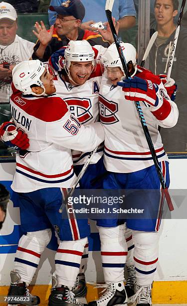 Christopher Higgins of the Montreal Canadiens celebrates a goal with teammates Francis Bouillon and Sergei Kostitsyn to tie the game in the third...