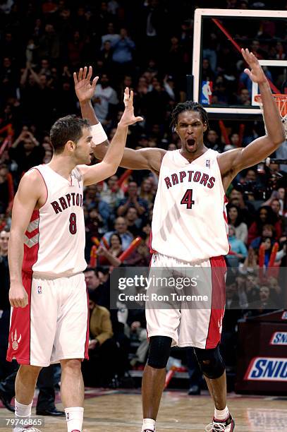 Chris Bosh and Jose Calderon of the Toronto Raptors celebrate a win against the New Jersey Nets on February 13, 2008 at the Air Canada Centre in...