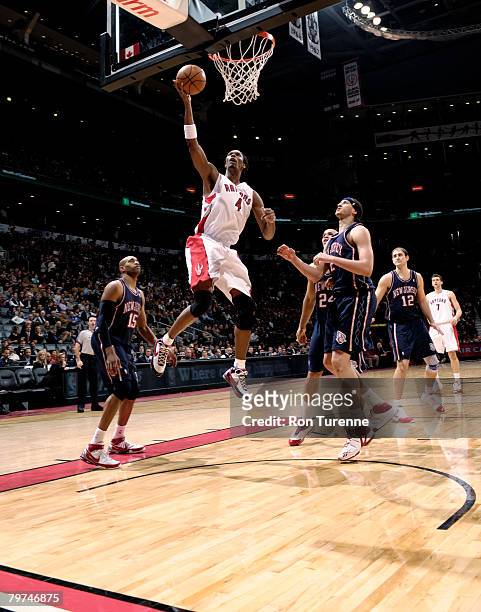Chris Bosh of the Toronto Raptors drives inside past Josh Boone of the New Jersey Nets on February 13, 2008 at the Air Canada Centre in Toronto,...