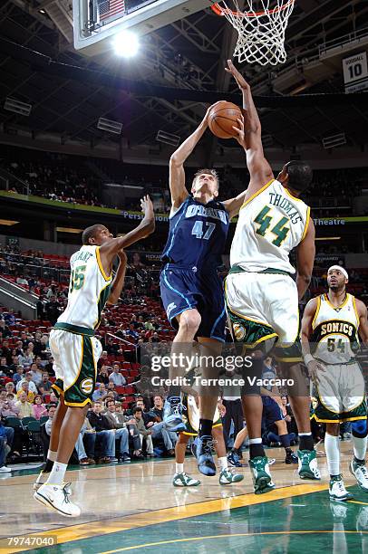 Andrei Kirilenko of the Utah Jazz goes to the basket against the defense of Kurt Thomas and Kevin Durant of Seattle SuperSonics on February 13, 2008...