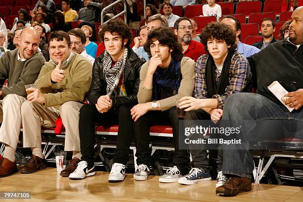 Members of the pop group The Jonas Brothers watch the Sacramento Kings play the Houston Rockets February 13, 2008 at the Toyota Center in Houston,...