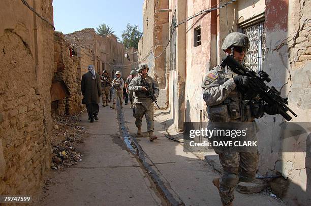 An American military training team and their Iraqi army colleagues conduct a foot patrol in the historic centre of the city of Samarra on February...