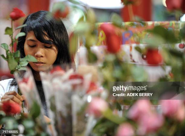Vendor arranges roses for sale at a mall in Jakarta on February 14, 2008 as presents for Valentine's day present. Indonesians along with the rest of...