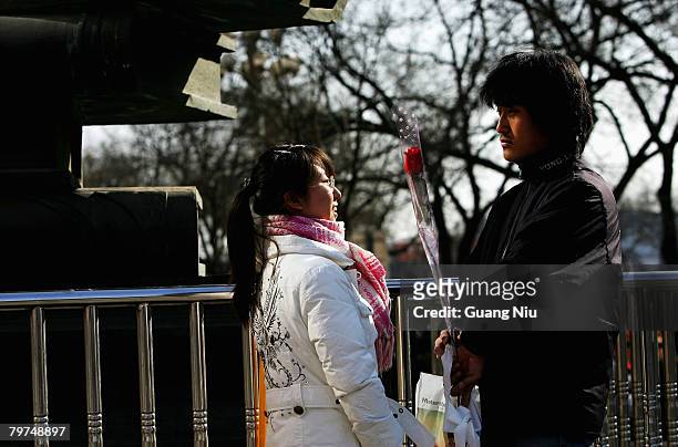 Chinese girl recieves a rose from her boyfriend on Valentine's Day February 14, 2008 in Beijing, China. Valentine's Day has become one of the most...