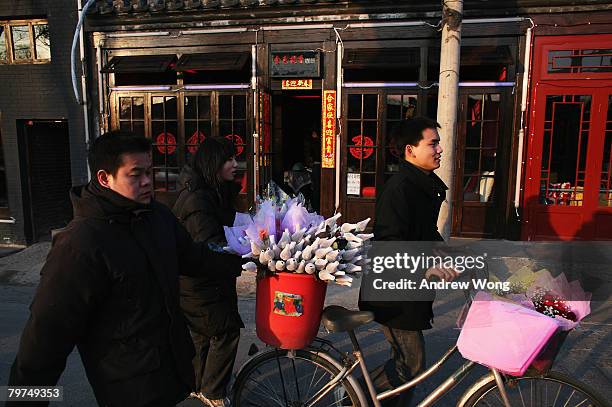 Chinese vendors sell roses outside bars on Valentine's Day February 14, 2008 in Beijing, China. Valentine's Day has become one of the most popular...