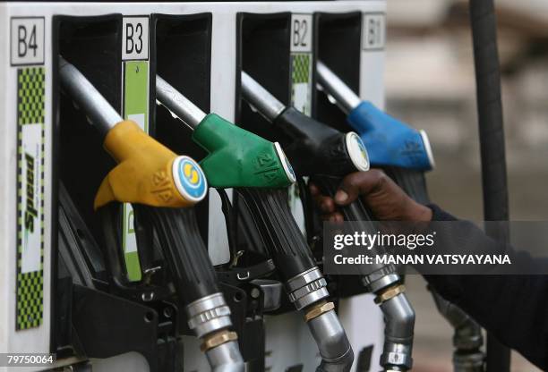 An Indian petrol pump attendant prepares to serve a customer at a petrol station in New Delhi on February 14, 2008. The Indian government has...