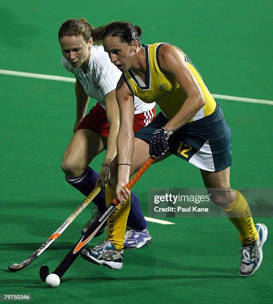 Sarah Thomas of Great Britain challenges Madonna Blyth of the Hockeyroos in action during the First Test match between the Australian Hockeyroos and...