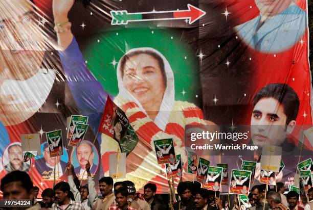 Poster of Benazir Bhutto and her son Bilawal Bhutto Zardari is seen in the background as PPP supporters gather at an election rally February 14, 2008...