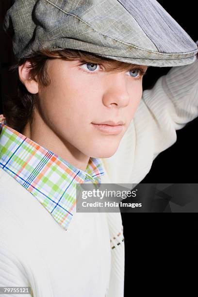 close-up of a teenage boy wearing a flat cap - flat cap stock pictures, royalty-free photos & images