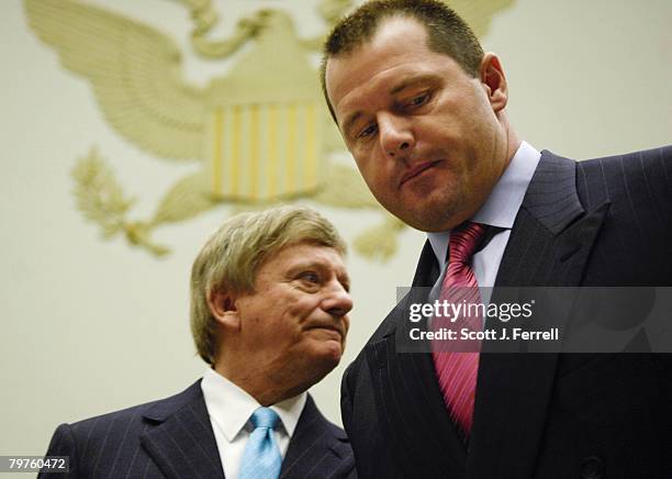 Former Major League pitcher Roger Clemens, right, with attorney Rusty Hardin, takes his seat to testify during the House Oversight and Government...