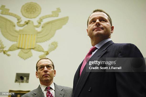 Former Major League pitcher Roger Clemens, right, with attorney Larry Breuer, takes his seat to testify during the House Oversight and Government...