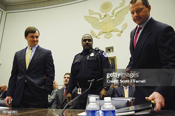 Mitchell report investigator Charlie Sheeler watches as former Major League pitcher Roger Clemens takes his seat to testify during the House...