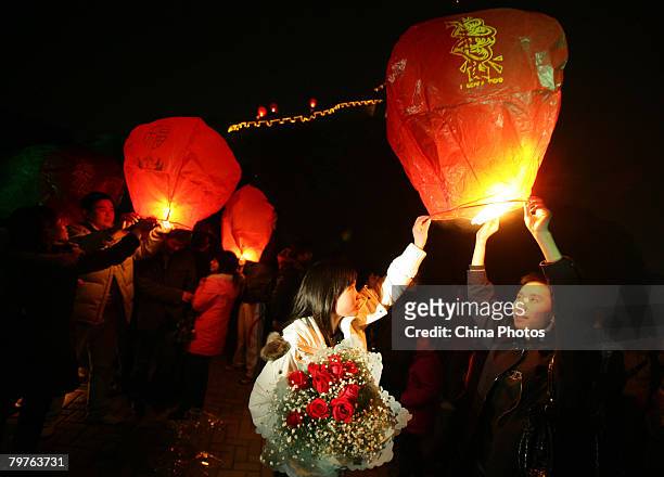 Chinese young lovers fly sky lanterns, or Kongming Lanterns to celebrate the upcoming Valentine's Day at the Foreigners Street on February 14, 2008...