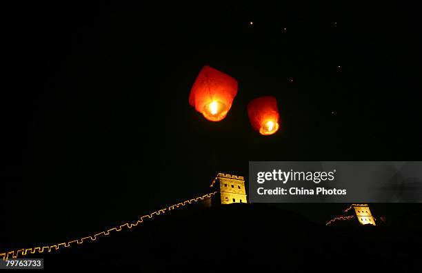 Sky lanterns, or Kongming Lanterns are flown by Chinese young lovers above the "Great Wall" decorations on the eve of the Valentine's Day at the...