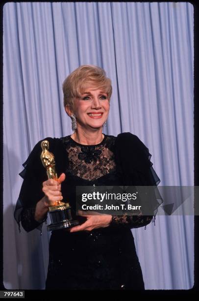 Actress Olympia Dukakis holds her Best Actress in a Supporting Role Oscar for "Moonstruck" at the Academy Awards April 11, 1988 in Los Angeles, CA....