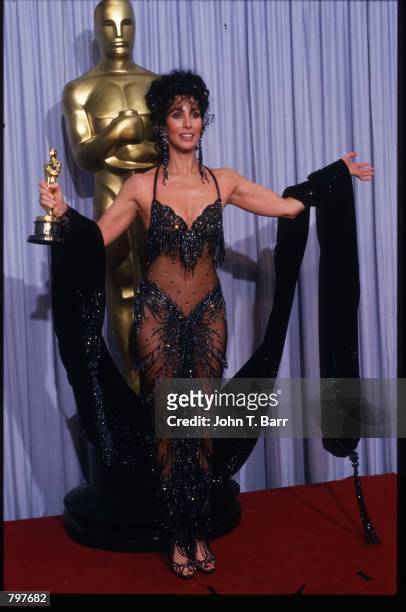 Actress Cher holds her Best Actress in a Leading Role Oscar for "Moonstruck" at the Academy Awards April 11, 1988 in Los Angeles, CA. The Academy...