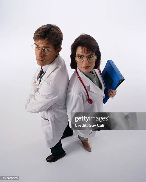 doctors back to back - cali morales stock pictures, royalty-free photos & images