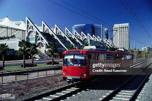 streetcar driving past the san diego convention center - san diego trolley stock pictures, royalty-free photos & images