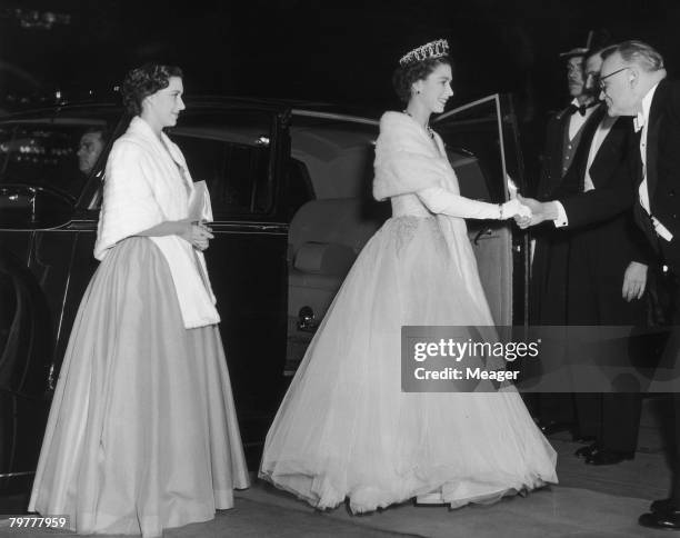 Queen Elizabeth II and her sister Princess Margaret arrive at the Empire cinema, Leicester Square, London, for the Royal Command Film Performance,...