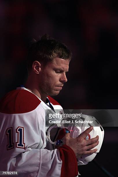 Saku Koivu of the Montreal Canadiens stands on the ice for the National Anthems prior to the start of the game against the Florida Panthers at the...
