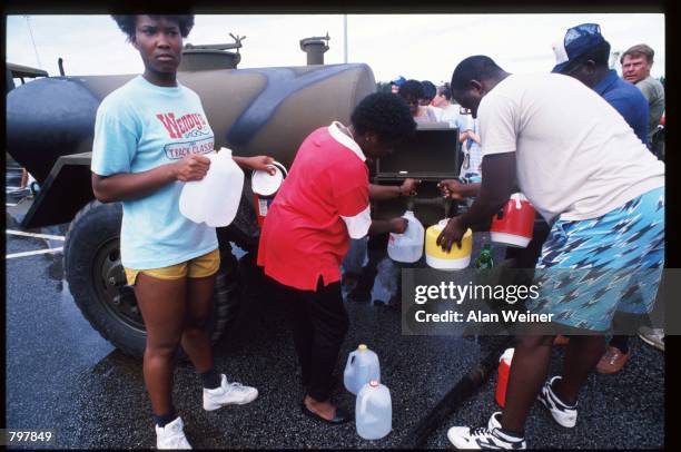 Residents fill jugs with water September 22, 1989 in Charleston, SC. Hurricane Hugo blasted the South Carolina coast with sustained winds of over 130...