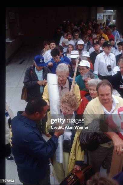 Security officer checks a woman's ID to verify that she is a resident of the Isle of Palms September 27, 1989 in South Carolina. Hugo is ranked as...