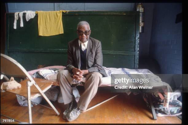 Man sits on a cot in a shelter September 27, 1989 in South Carolina. Hugo is ranked as the eleventh most intense hurricane to strike the US this...