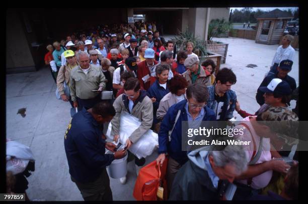 Security officer checks a man's ID to verify that he is a resident of the Isle of Palms September 27, 1989 in South Carolina. Hugo is ranked as the...