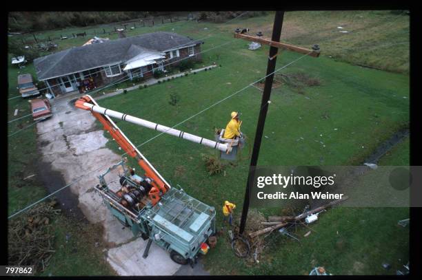 Worker repairs a telephone wire September 27, 1989 in South Carolina. Hugo is ranked as the eleventh most intense hurricane to strike the US this...