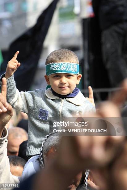 Palestinian boy raises his hand during a protest organised by Hamas in the northern Gaza Strip town of Jabalia on February 15, 2008 against Danish...