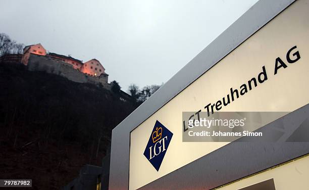The company nameplate of the LGT Treuhand AG is seen beneath the Liechtenstein castle on February 15, 2008 in Vaduz, Liechtenstein. Suspected tax...